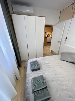 a bedroom with a bed with two trays on it at LOCATION ! Sofia Opera Apartment next to ALEXANDER NEVSKY CATHEDRAL in Sofia