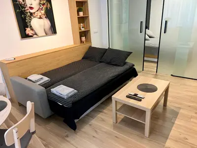 a living room with a bed and a table at LOCATION ! Sofia Opera View Apartment next to ALEXANDER NEVSKY CATHEDRAL in Sofia