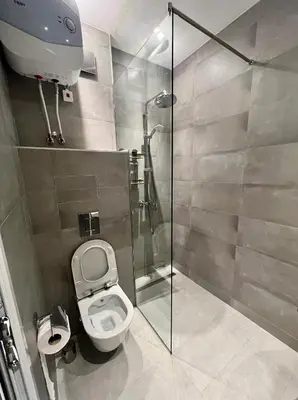a bathroom with a toilet and a glass shower stall at LOCATION ! Sofia Opera View Apartment next to ALEXANDER NEVSKY CATHEDRAL in Sofia