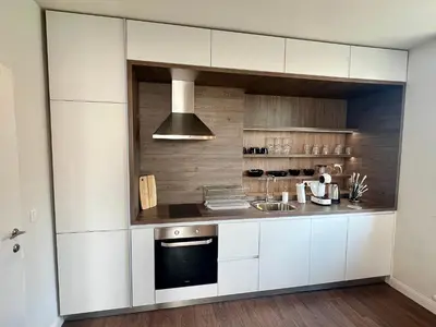 a kitchen with white cabinets and a stove at LOCATION ! LOCATION ! LOCATION ! City Garden View Apartment in Sofia