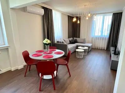 a living room with a table and chairs and a couch at LOCATION ! LOCATION ! LOCATION ! City Garden View Apartment in Sofia