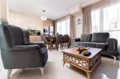 a living room with two chairs and a table at Modern & Elegant City Center Apartments in Plovdiv
