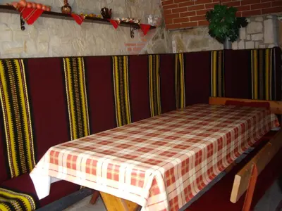 a room with a table with a plaid table cloth at Guest House Rusalka in Shipkovo