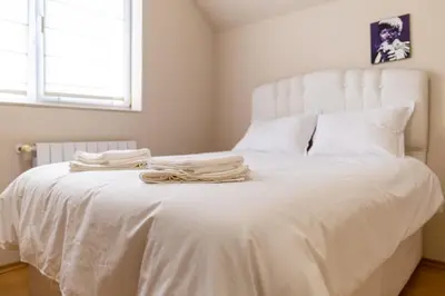 a bedroom with a white bed with towels on it at Spacious apartment in the city center in Plovdiv