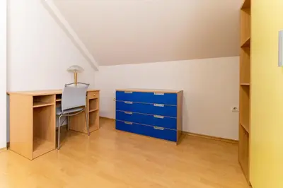 an empty room with a desk and a blue cabinet at Spacious apartment in the city center in Plovdiv