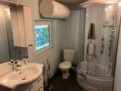 a bathroom with a shower and a toilet and a sink at Galeria In The Garden in Plovdiv