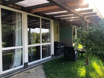 a screened in porch with a pergola at Galeria In The Garden in Plovdiv