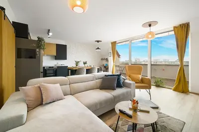 a living room with a couch and a table and a kitchen at Top Central Maisonette with Underground parking in Sofia