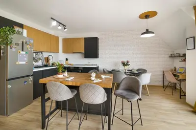 a kitchen and dining room with a table and chairs at Top Central Maisonette with Underground parking in Sofia