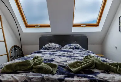 a bedroom with a bed with towels on it at Top Central Maisonette with Underground parking in Sofia