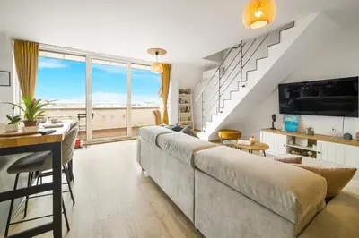 a living room with a large couch and a table at Top Central Maisonette with Underground parking in Sofia