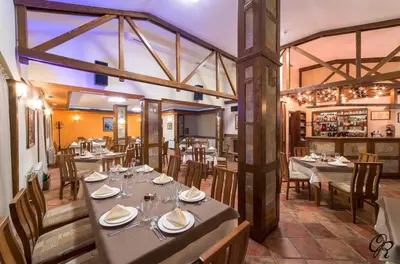 a restaurant with tables and chairs in a room at Secret Lake 533 at Oak Residence in Smolyan