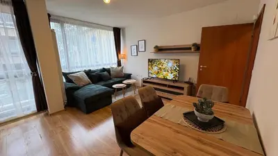 a living room with a table and a couch at Two-bedroom Apartments - Tundza in Sofia