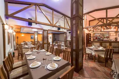 a restaurant with tables and chairs and a bar at Deer Lake 521 at Oak Residence Hotel & Relax in Smolyan