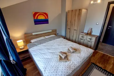 a bedroom with a bed with two towels on it at Мансарда с фантастични гледки и две спални in Chepelare