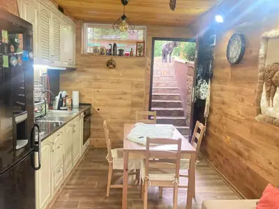 a kitchen and dining room with a table and chairs at Green View 1 in Skrino