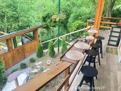 a patio with tables and stools on a deck at Green View 1 in Skrino