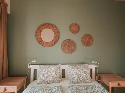 a bedroom with a bed and mirrors on the wall at Vitosha View Apartment & Free Parking in Sofia