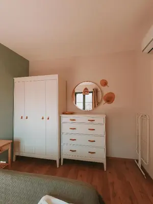 a bedroom with a white dresser and a mirror at Vitosha View Apartment & Free Parking in Sofia