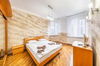 a bedroom with a bed and a desk and a tv at Sofia University Life Apartment in Sofia