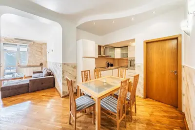 a kitchen and dining room with a table and chairs at Sofia University Life Apartment in Sofia