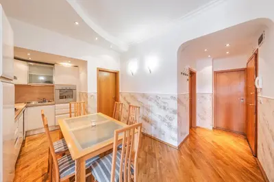 a kitchen and dining room with a table and chairs at Sofia University Life Apartment in Sofia