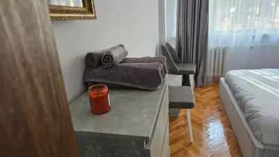 a room with a bed and a table with towels at Urban Comfort 1BR near South Park with Balcony in Sofia