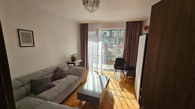 a living room with a couch and a table at Urban Comfort 1BR near South Park with Balcony in Sofia