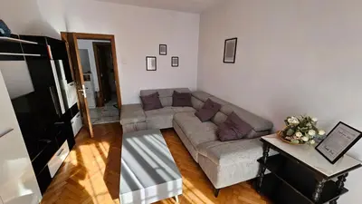 a living room with a couch and a table at Urban Comfort 1BR near South Park with Balcony in Sofia