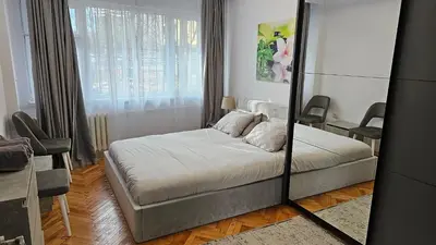 a bedroom with a bed and a mirror at Urban Comfort 1BR near South Park with Balcony in Sofia