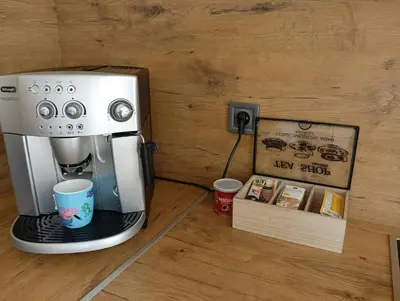 a coffee machine sitting next to a box with a cup at Artistic loft with AMAZING VIEW in Plovdiv