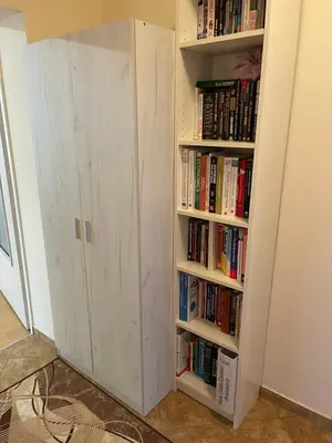 a book shelf filled with books next to a door at Къща Бети самостоятелни апартаменти с двор край Пловдив in Skutare