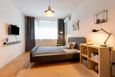 a small bedroom with a bed and a window at Our Place in Sofia