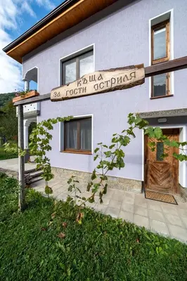 a house with a sign in front of it at Къща за гости Остриля in Cherni Vit