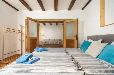 a bedroom with a large bed with blue towels on it at Къща за гости Остриля in Cherni Vit