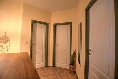 a dining room with two doors and a table at Вила Форте Villa Forte in Pamporovo
