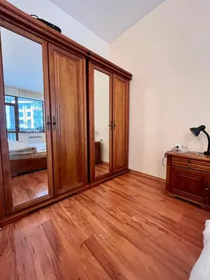 a bedroom with wooden cabinets and a wooden floor at Cedar Heights 2 in Pamporovo