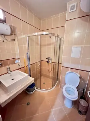 a bathroom with a shower and a toilet and a sink at Cedar Heights 2 in Pamporovo