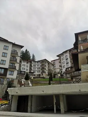 an overpass in a city with apartment buildings at Cedar Heights 2 in Pamporovo