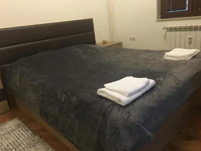 a bed with two towels sitting on top of it at Luxury apartment Sofia top centre in Sofia