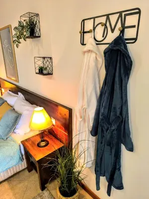 a room with a bed and a coat hanging on a wall at Luxury SPA Apartments TOP resort Bansko - incl wellness in Bansko