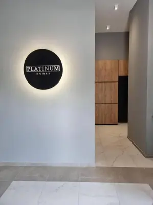 a lobby with a black and white sign on a wall at Urban Exec Suite with Free Gym Pass, Full Office Setup and Designated Parking Space in Plovdiv