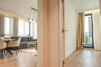 a living room with a couch and a table at Urban Exec Suite with Free Gym Pass, Full Office Setup and Designated Parking Space in Plovdiv
