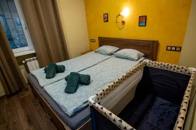 a bed with two green bow ties on it at Comfort & Cozy Apartment in Sofia Center in Sofia
