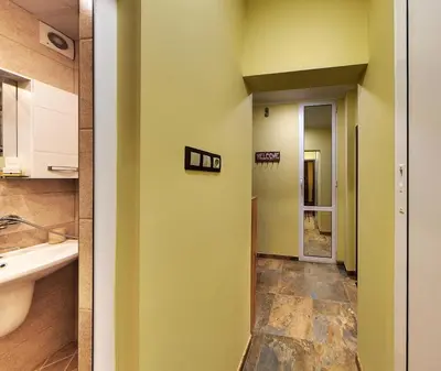 a bathroom with yellow walls and a sink at Comfort & Cozy Apartment in Sofia Center in Sofia