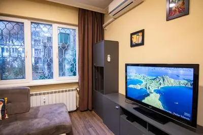 a living room with a large flat screen tv at Comfort & Cozy Apartment in Sofia Center in Sofia