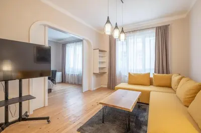 a living room with a couch and a tv at Gorgeous 2 BDRM fully equipped flat, TOP location in Sofia