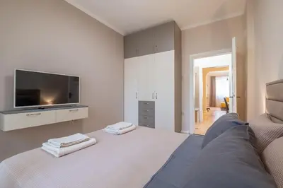 a living room with a large bed with a tv at Gorgeous 2 BDRM fully equipped flat, TOP location in Sofia