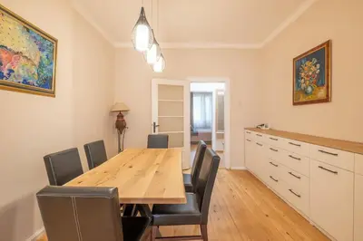 a dining room with a wooden table and chairs at Gorgeous 2 BDRM fully equipped flat, TOP location in Sofia