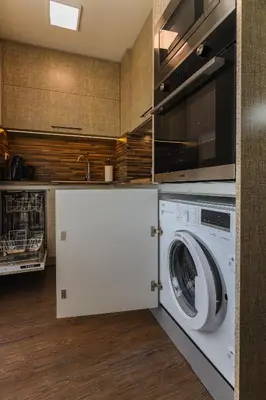 a kitchen with a washing machine and a microwave at Old Town View in Plovdiv